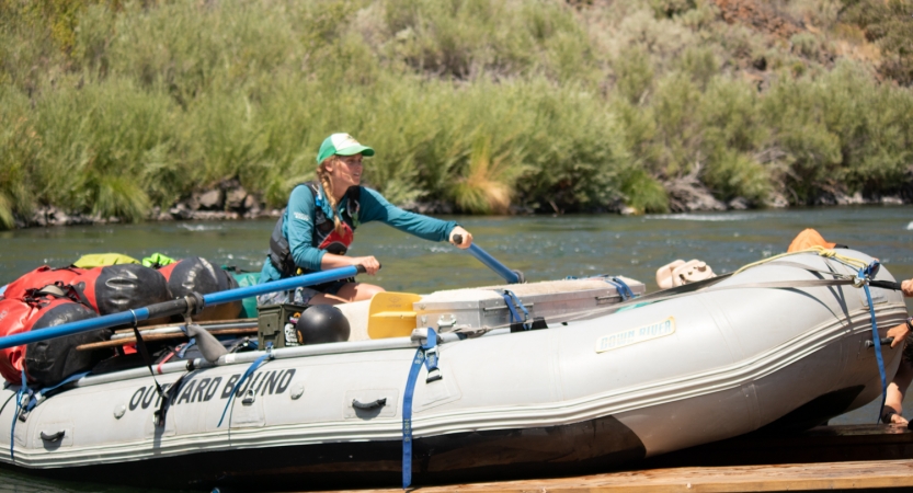 a person launches a raft off a trailer on an outward bound expedition 